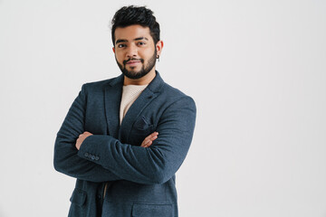 Wall Mural - Indian man standing with arms folded isolated over white background