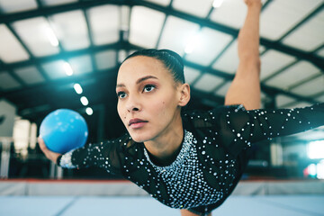 Wall Mural - Woman, gymnastics and stretching in balance with ball for training or practice at the indoor gym. Athletic female professional gymnast or acrobat in warm up stretch for exercise, workout or fitness