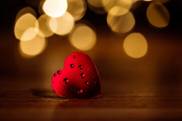 red heart on a background of golden bokeh