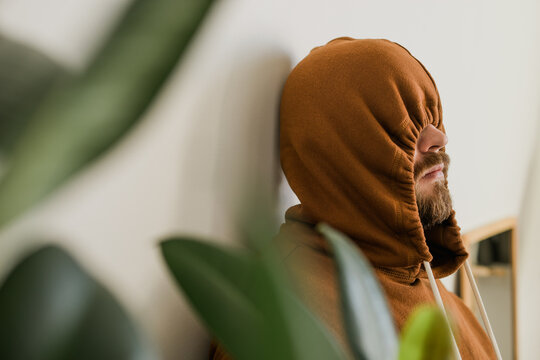 depressed unhappy man covered hood her face - escapism and loneliness mental problem concept. bipola