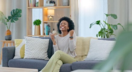 Poster - African woman celebrating a new job while sitting at home on a couch. A young females loan is approved via an email on her phone. A happy and excited lady cheering for a promotion on a sofa