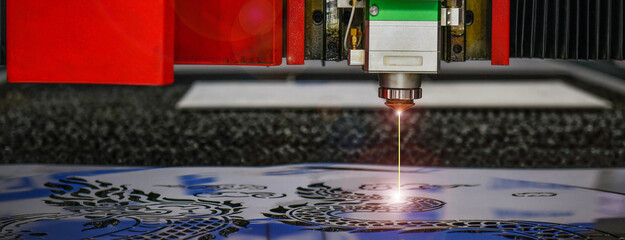 Wall Mural - industrial laser cut machine while cutting the sheet metal with the sparking light.