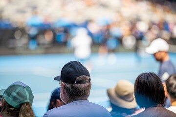 Wall Mural - tennis fan watching a tennis match at the australian open eating food and drinking