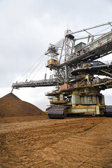 Wall Mural - An huge excavator on a coal surface mine. Interesting geological forms of tailings dump in an open pit coal mine.