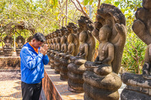Kalasin, Thailand, February 1, 2023. Buddhist Men Pay Respect To The Naga At Phu Dan Hai Temple, Kalasin Province, Thailand.