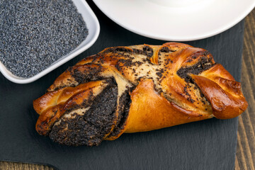 Fresh bun with poppy seed filling on the table