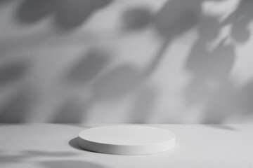 Empty white round podium with lights and shadows on light grey background. Pedestal for product presentation. Display for beauty cosmetic advertising. Minimal still life mockup.