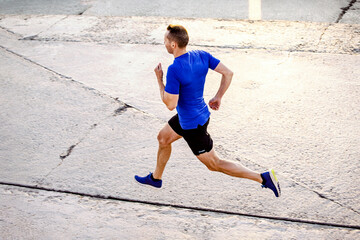 Wall Mural - middle-aged male runner run on road