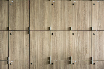 Wooden lockers with key in locker room at school sport club office.