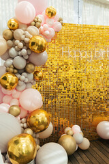 Wall Mural - A large festive photo zone for a birthday, decorated with gold sequins, pink, gray and gold balloons of different sizes. Celebrating concept