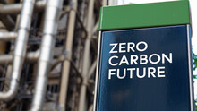 Zero Carbon Future On A Sign In Front Of An Industrial Building	