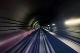 Fototapeta  - Railroad track in underground tunnel in blurred motion. Point of view from train..