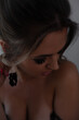 © Вероника Зеленина - Portrait of a beautiful girl with smokey eye makeup and juicy lustre on her sown jacket lips/ The girl has an evening professional hairstyle made of hair. The woman is wearing hanging earrings
