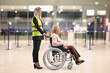 © Ljupco Smokovski - Female assitance worker at the airport with an older woman in a wheelchair