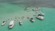 © StockedandLoaded - Aerial view of yachts and tour boats in sting ray city in Cayman Islands in shallow turquoise water