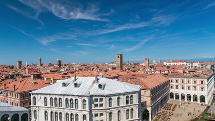 Wall Mural - Top panoramic view on central busy canal in Venice timelapse, on both sides masterpieces of Venetian architecture, sailing on gondolas and boats. Blue cloudy sky at summer day over red roofs