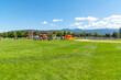 Families play at Pavilion Park during a summer festival and fair in the Spokane Washington suburb of Liberty Lake, Washington.	