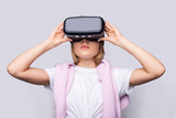 Fototapeta Do pokoju - Portrait of young woman playing VR game wearing VR headset, half body shot. Young generation choose virtual reality relaxation concept.