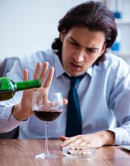 Poster - Male employee drinking alcohol and smoking cigarettes at workpla