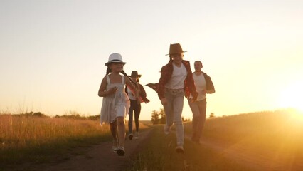 Wall Mural - happy family children kid together run in the park at sunset fun silhouette. people in the park concept mom dad daughter and son joyful run. happy family and little baby child summer kid dream