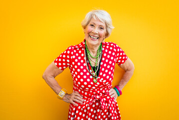 Happy grandmother posing on colored backgrounds