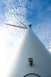 Modern futuristic wind turbine, low angle view with cloud sky