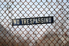 No Trespassing Sign Attached To Fence 