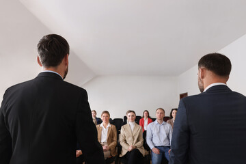 Wall Mural - Business trainers giving lecture in conference room