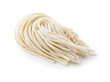 Fresh udon noodles placed on a white background.