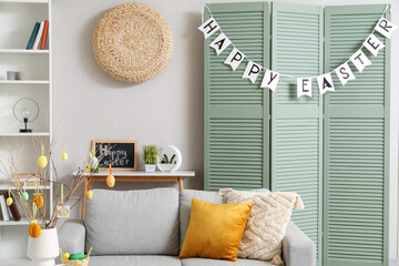 Sticker - Interior of living room decorated for Easter celebration with sofa and folding screen