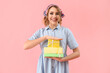 © Pixel-Shot - Happy young woman with gifts on pink background