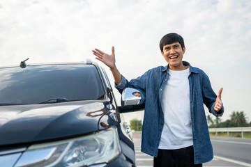 Wall Mural - Young handsome asian man getting the new car. He hugged his car and was very happy touching detail interior . Buy or rent car concept.