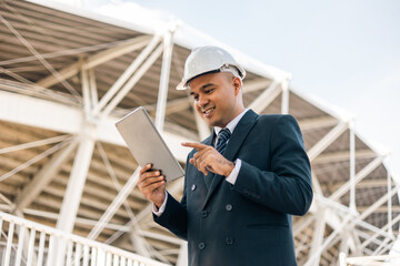 Businessman manager owner real estate working with digital tablet at modern office building. Cooperation of architect designer. Engineer with safety helmet checking at working construction site