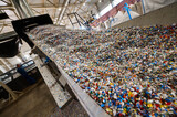 Fototapeta Miasto - Chopped waste plastic transported by production line