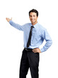 A handsome young salesperson or an executive in formal dress smiling and presenting at a  copy space posing with his hands on his hip isolated on a png background.