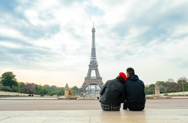 cheerful happy couple in love visiting Paris city centre and Eiffel Tower