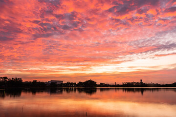 Wall Mural - sunset nearly fall from the sky on the horizon reflected into the water