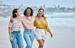 © K Davis/peopleimages.com - Diversity, friends and beach, hug and walk while laughing, relax and talking against nature background. Travel, women and group embrace while walking at the sea, happy and smile on ocean trip in Bali