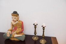 Buddha Statue In Lotus Position With Two Candles, Munich, Bavaria, Germany