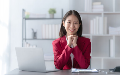 Wall Mural - Young pretty attractive asia chinese half thai woman mixed race working with online balance sheet outsource, online bookkeepers helpful consult customized accounting reports and financial statements.