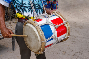 Dominican Republic. The beach musician plays the drum. Drummer. Close-up of the hand and drum. Dominican people.