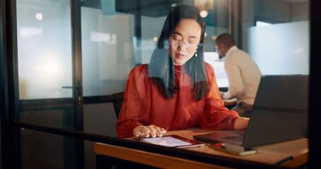 Laptop, night office and Asian woman typing email, sales proposal or finishing project deadline. Computer, tech and happy female employee working late in dark workplace, researching or writing report