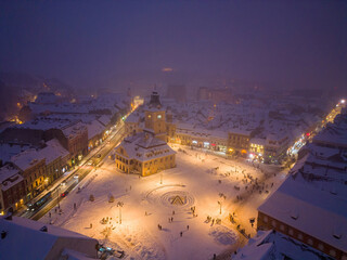 Wall Mural - Aerial drone view of Brasov town in winter at night, Romania.