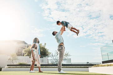 Family, sky and real estate with a man lifting his son outdoor while bonding as a new homeowner group. Kids, love or summer with parents and children standing outside in the garden of a home property