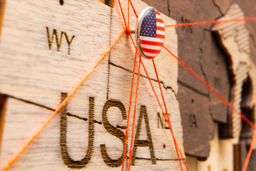 Wall Mural - USA flag pins and red thread for traveling and planning trips. Planning of logistics routes or spheres of influence in geopolitics