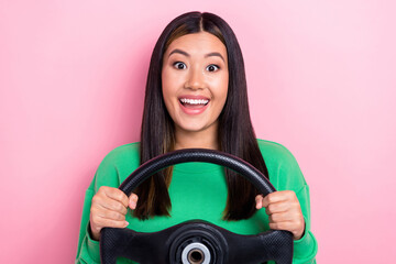 Sticker - Photo of young overjoyed excited junior car driver lady hold steering wheel enjoy her new transport car isolated on pastel pink color background