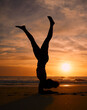© Lumeez/peopleimages.com - Yoga woman, silhouette or handstand on sunset beach, ocean or sea in workout or relax exercise training. Yogi, pilates or sand balance pose at sunrise for healthcare wellness fitness or strong body