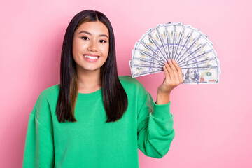 Sticker - Photo of good mood cute girl dressed green sweatshirt rising dollars fan isolated pink color background