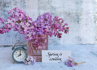 Spring is coming card with lilac flowers and clock 