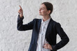 Portrait with copy space of charming, pretty, nice, stylish, brunette, trendy woman in shirt and black blazer, pointing forefinger on empty place